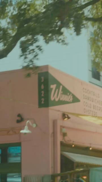 Exterior of Winnie's, a pink corner building in Midtown Houston