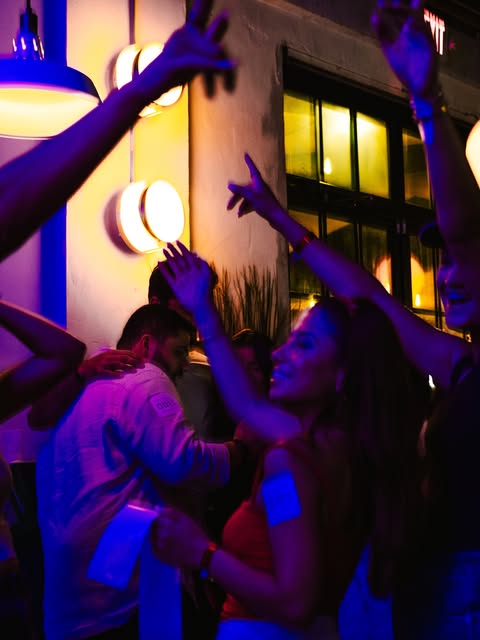 Crowd dancing under purple light